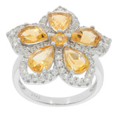 Elegant flower-shaped ring featuring pear yellow gemstones and sparkling accents in sterling silver.